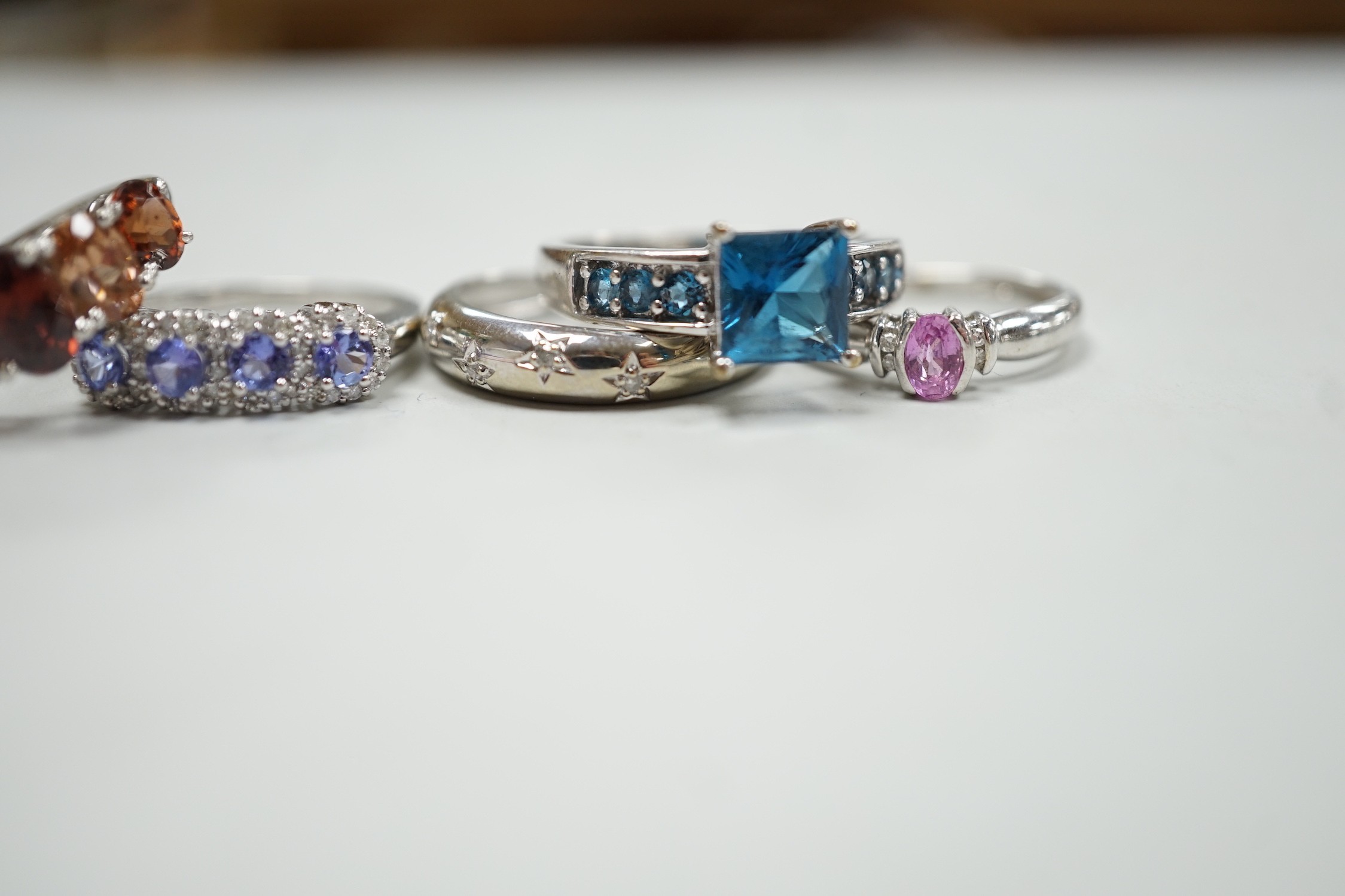 Five assorted modern 9ct white gold and gem set dress rings, including gypsy set diamond chip, gross weight 12.6 grams.